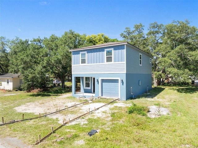 view of front of property with a front yard and a garage