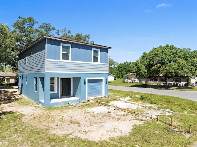 back of house featuring a garage