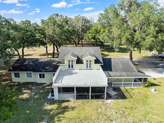 back of property featuring a lawn