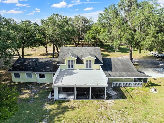 4350 E Hinson Ave, Haines City, FL 33844 - back of house featuring french doors, a sunroom, a lawn, and view of scattered trees