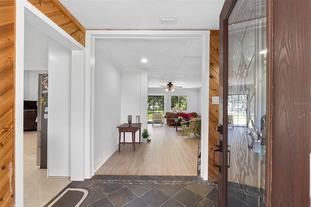 foyer featuring ceiling fan, hardwood / wood-style flooring, and a textured ceiling