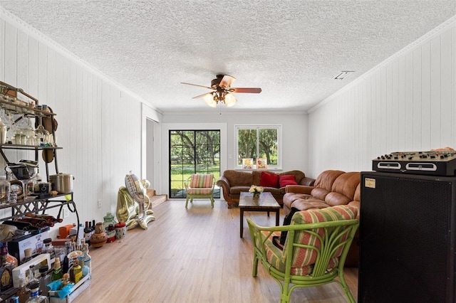 4350 E Hinson Ave, Haines City, FL 33844 - living area featuring wood finished floors, ceiling fan, ornamental molding, and wooden walls