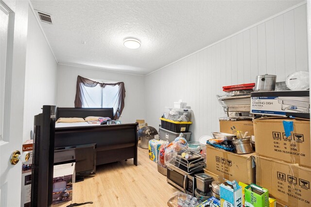 4350 E Hinson Ave, Haines City, FL 33844 - bedroom with wood finished floors, a textured ceiling, and ornamental molding