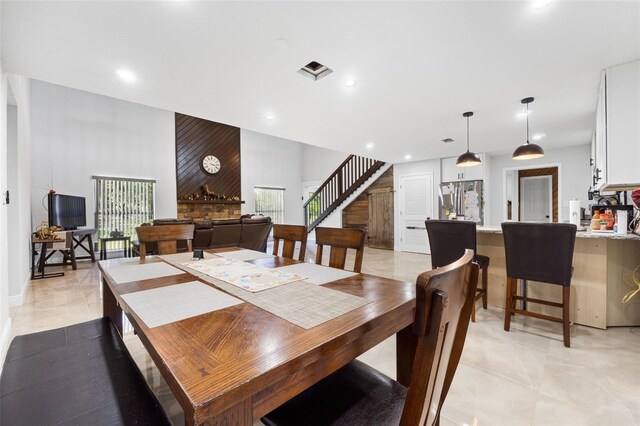 4350 E Hinson Ave, Haines City, FL 33844 - dining space featuring stairs, recessed lighting, a towering ceiling, and baseboards