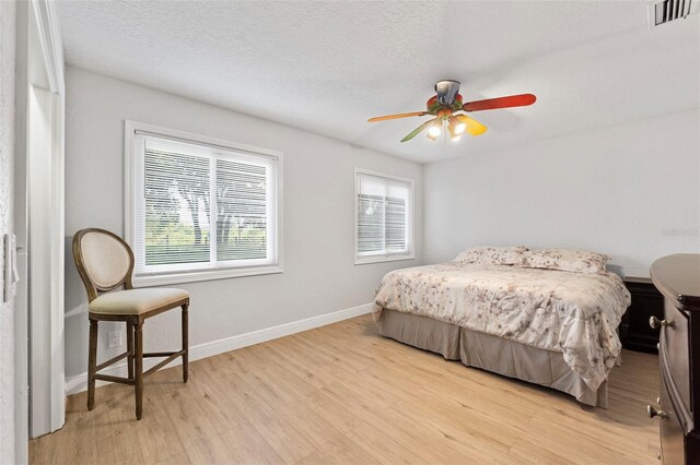 4350 E Hinson Ave, Haines City, FL 33844 - bedroom featuring multiple windows, light wood-style flooring, baseboards, and ceiling fan