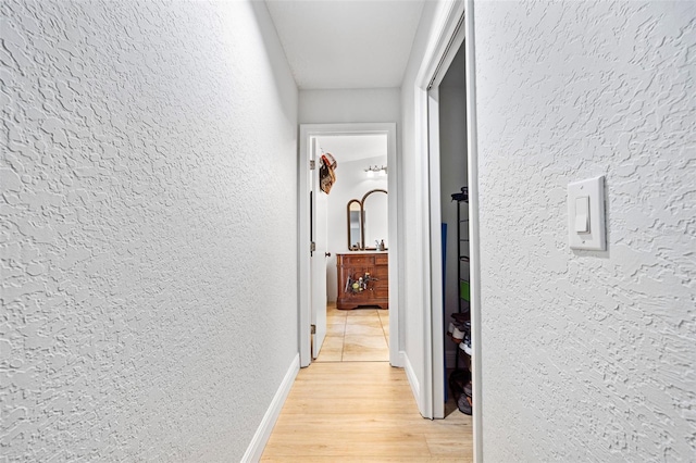 hallway with light hardwood / wood-style flooring