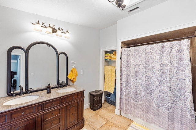 bathroom featuring vanity, tile patterned flooring, and curtained shower