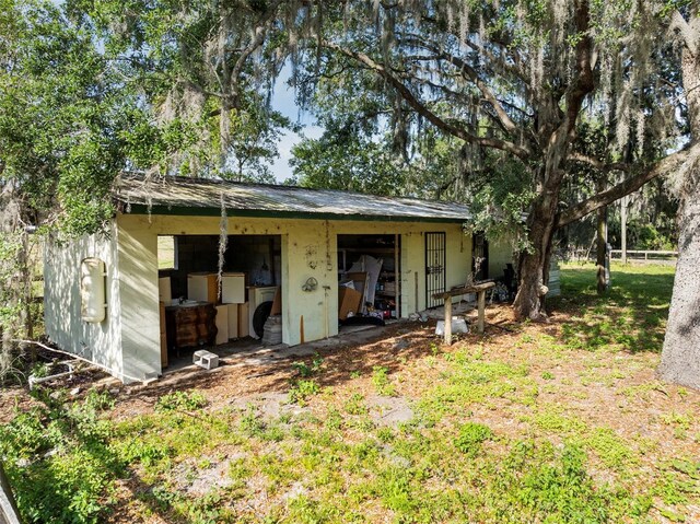 4350 E Hinson Ave, Haines City, FL 33844 - back of property with an outdoor structure and an outbuilding