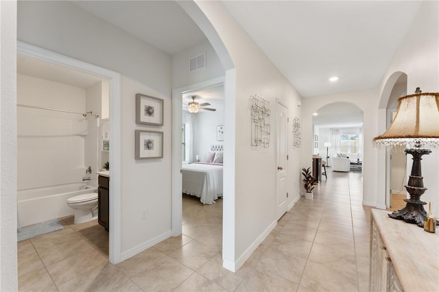 corridor featuring light tile patterned floors