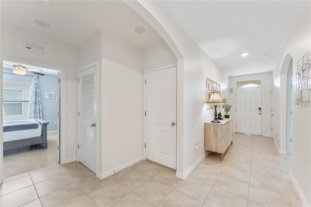 entryway with light tile patterned flooring and ceiling fan