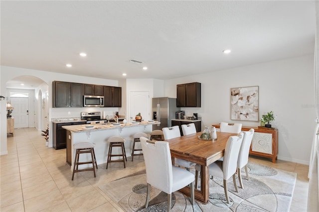 tiled dining room featuring sink