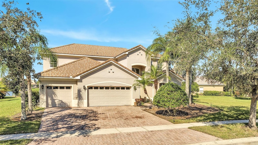 mediterranean / spanish-style home with a garage and a front yard