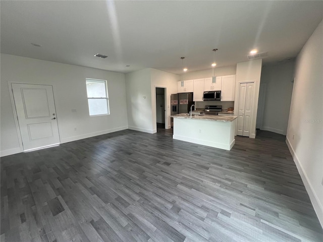 unfurnished living room featuring dark hardwood / wood-style flooring and sink