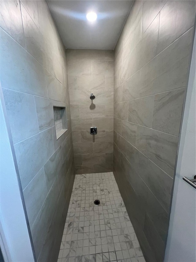 bathroom with tiled shower