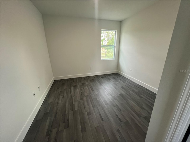 spare room featuring dark hardwood / wood-style floors