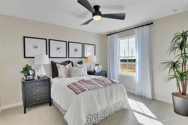 bedroom with light carpet and ceiling fan