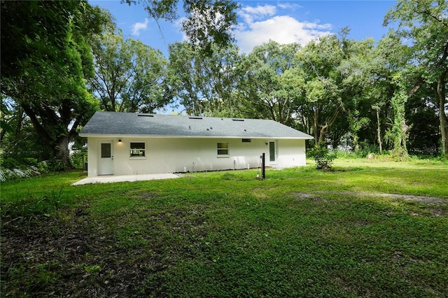 back of property featuring a yard and a patio area