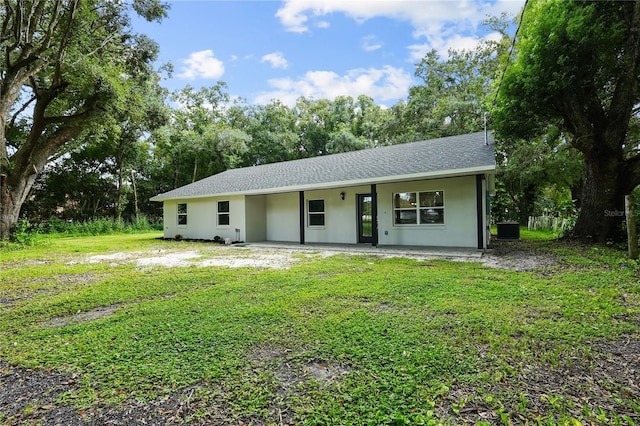 ranch-style house with a front lawn and central air condition unit