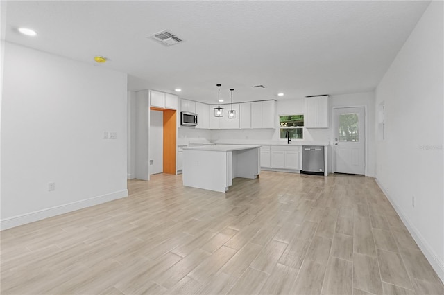 unfurnished living room with sink and light hardwood / wood-style flooring