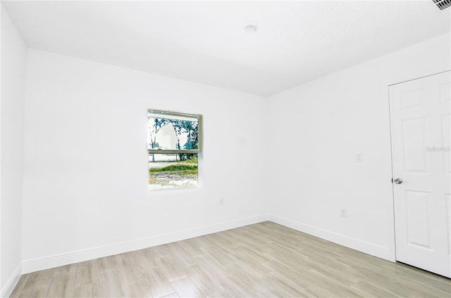 spare room featuring light wood-type flooring