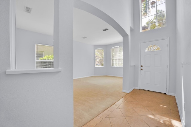 tiled foyer entrance with a healthy amount of sunlight