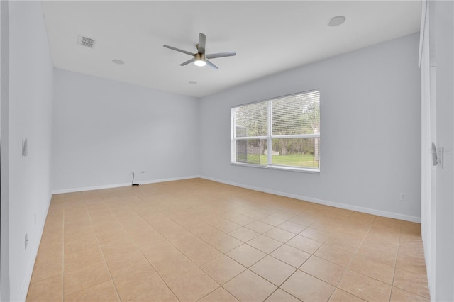 empty room featuring ceiling fan and light tile patterned floors