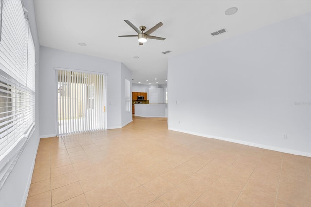 unfurnished living room with ceiling fan and light tile patterned floors