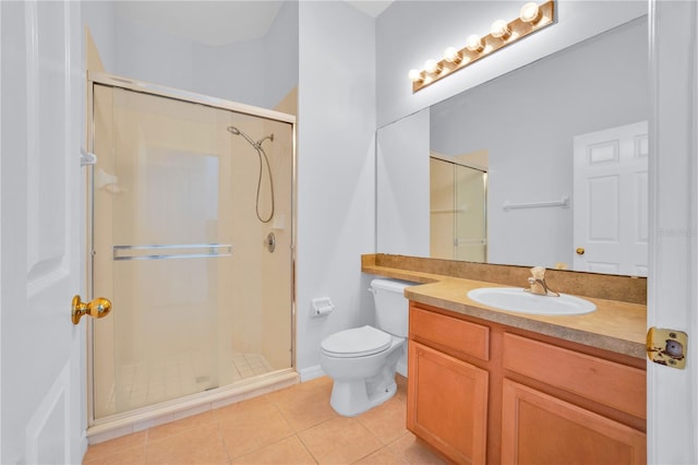 bathroom featuring toilet, tile patterned floors, vanity, and an enclosed shower