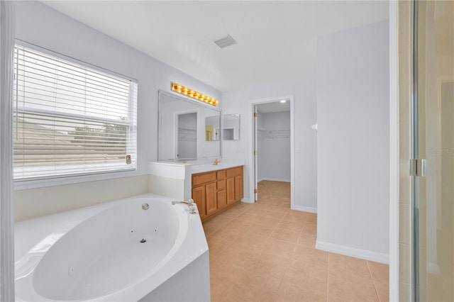 bathroom with tile patterned floors, vanity, and plus walk in shower