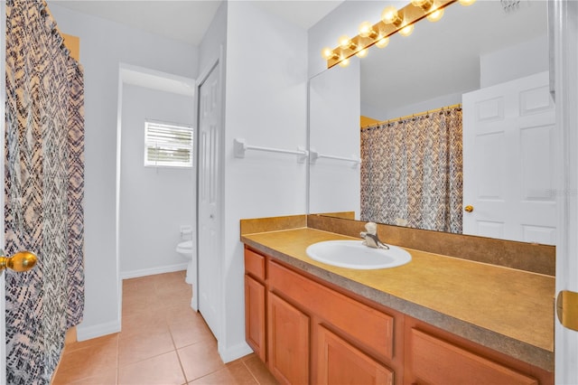 bathroom featuring toilet, tile patterned floors, and vanity