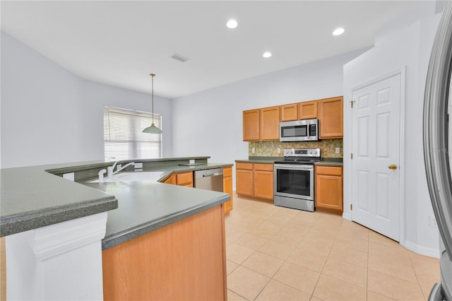 kitchen with light tile patterned floors, stainless steel appliances, decorative backsplash, pendant lighting, and sink