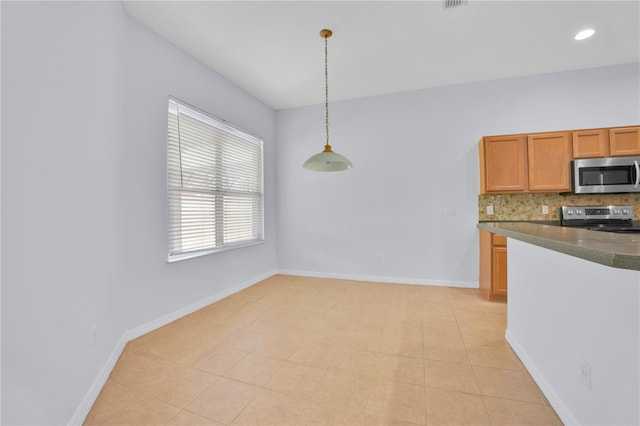 kitchen featuring pendant lighting, light tile patterned floors, stainless steel appliances, and tasteful backsplash