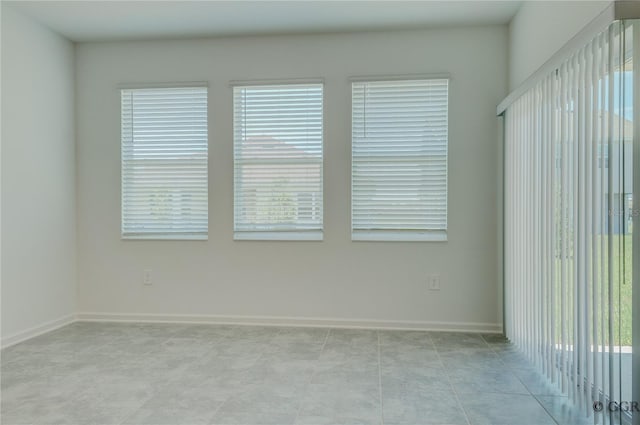 unfurnished room featuring light tile patterned floors