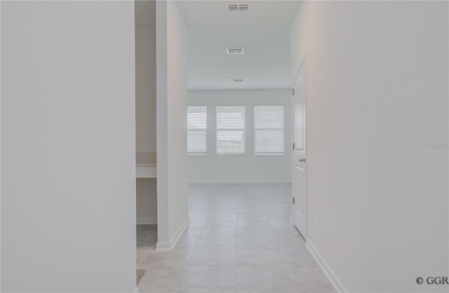 hall with light tile patterned flooring