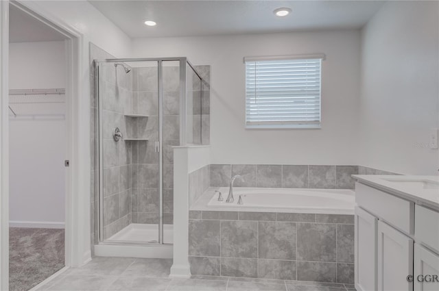 bathroom featuring tile patterned floors, independent shower and bath, and vanity