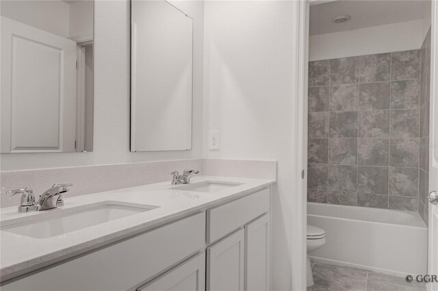 bathroom with vanity, toilet, and tile patterned floors