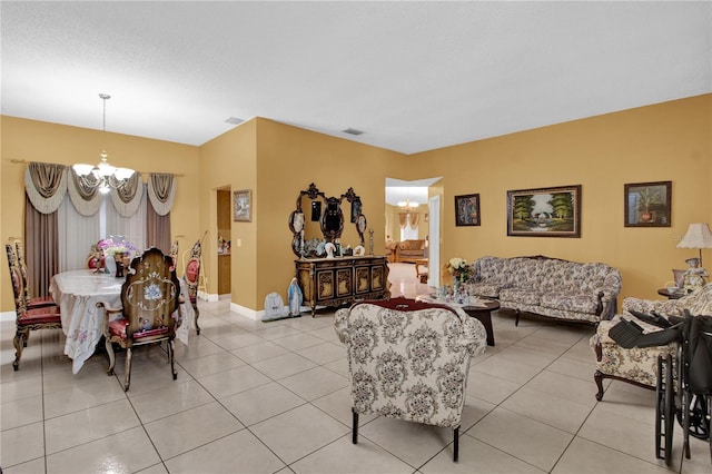 living room with an inviting chandelier and light tile patterned floors