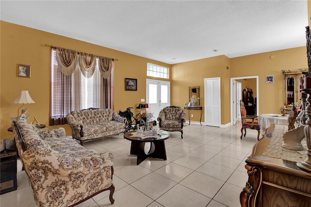 living room with a textured ceiling and light tile patterned floors