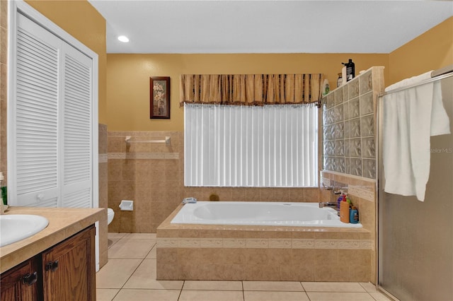 bathroom with vanity, tile walls, shower with separate bathtub, and tile patterned floors