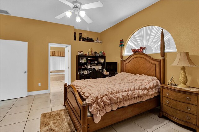 tiled bedroom featuring ceiling fan and ensuite bathroom