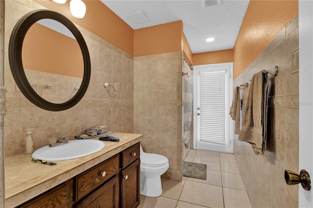 bathroom featuring tile walls, toilet, and tile patterned floors