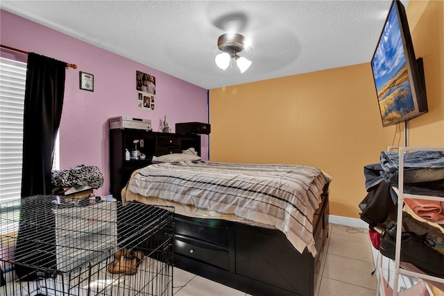 tiled bedroom with a textured ceiling and ceiling fan