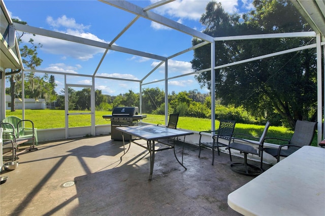 view of patio / terrace with grilling area and a lanai