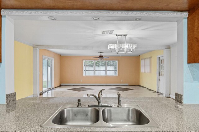 912 Ave T SE, Winter Haven, FL 33880 - kitchen featuring a ceiling fan, crown molding, visible vents, a sink, and hanging light fixtures