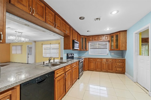 kitchen with sink, a notable chandelier, stainless steel appliances, light tile patterned floors, and decorative light fixtures