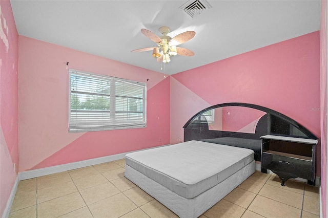 bedroom with ceiling fan and light tile patterned floors