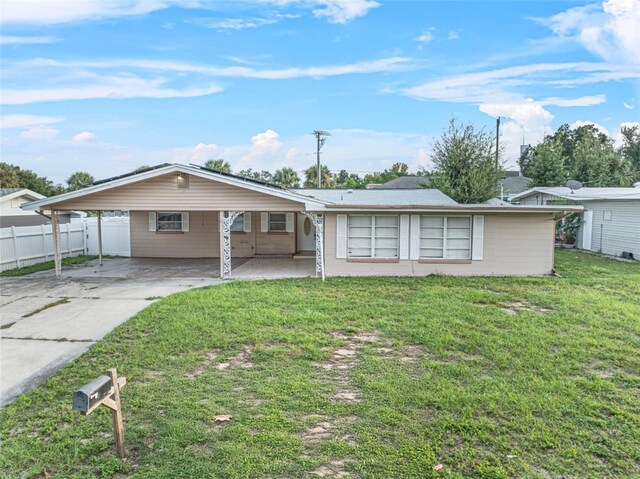 912 Ave T SE, Winter Haven, FL 33880 - single story home with a front yard, fence, a carport, and driveway