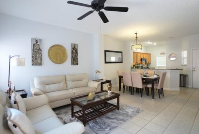 living room with ceiling fan and light tile patterned flooring