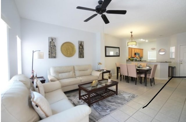 living room with ceiling fan and light tile patterned flooring