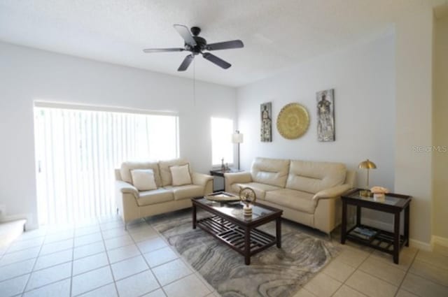 tiled living room with ceiling fan